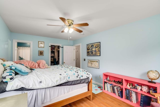 bedroom with hardwood / wood-style flooring and ceiling fan