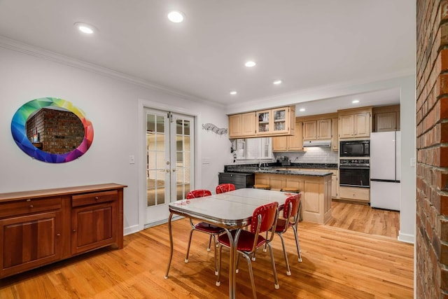 dining area with ornamental molding, french doors, light hardwood / wood-style flooring, and plenty of natural light