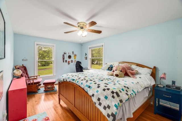 bedroom with ceiling fan and hardwood / wood-style flooring