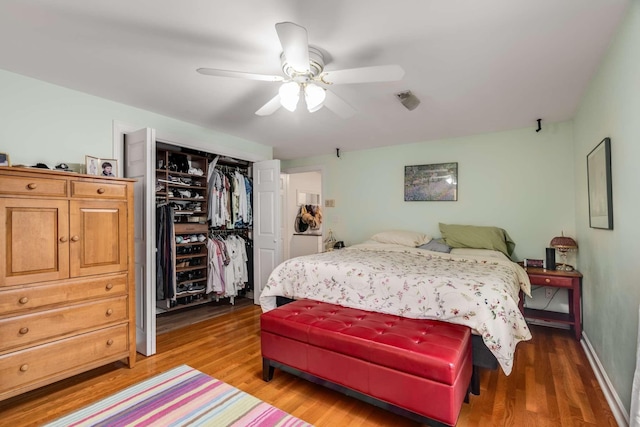 bedroom featuring ceiling fan, hardwood / wood-style floors, and a closet