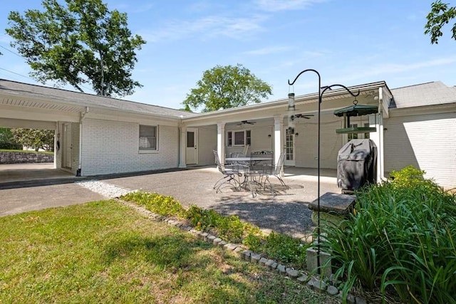 rear view of house with a patio area, ceiling fan, and a yard