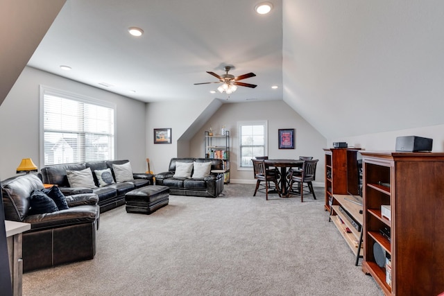 carpeted living room with vaulted ceiling and ceiling fan