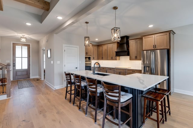 kitchen featuring custom exhaust hood, stainless steel appliances, hanging light fixtures, beam ceiling, and sink