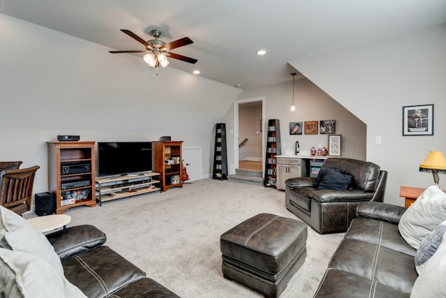 living room featuring ceiling fan, vaulted ceiling, and light carpet