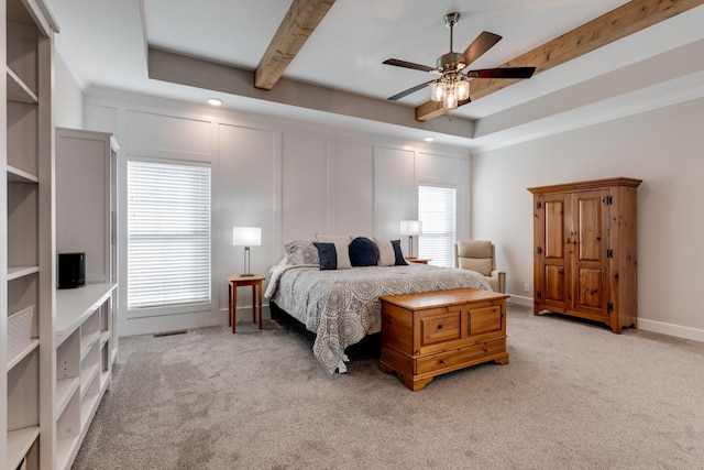 bedroom featuring ceiling fan, ornamental molding, and light colored carpet