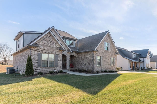 view of front of home with a front yard and central AC