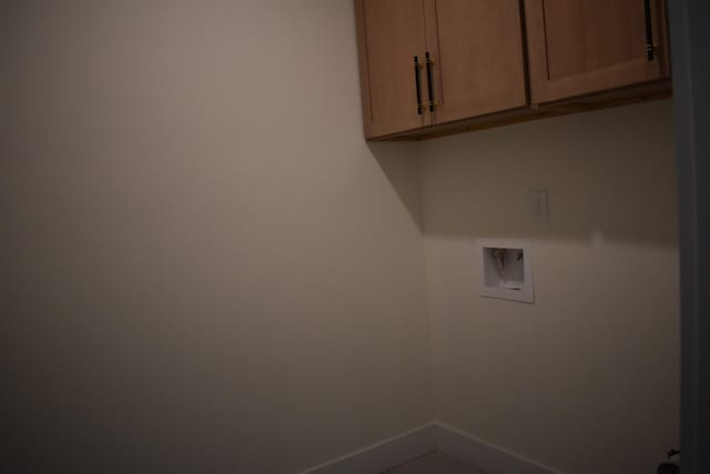 laundry room with hookup for a washing machine and cabinets