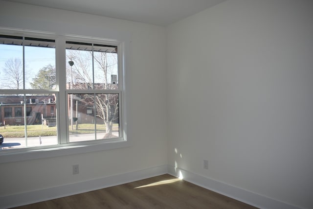 unfurnished room with dark hardwood / wood-style flooring