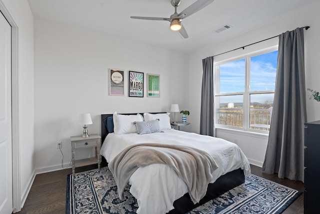 bedroom with ceiling fan and dark hardwood / wood-style flooring