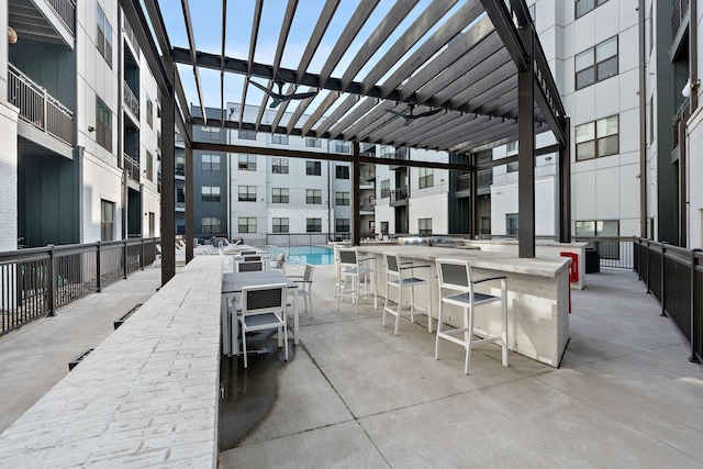 view of patio with a pergola and an outdoor bar