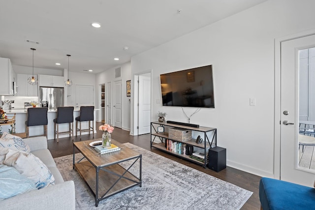 living room with dark hardwood / wood-style flooring