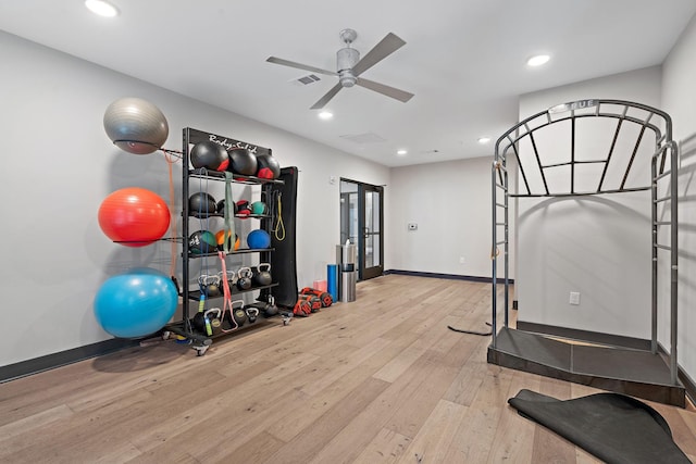 exercise area featuring light hardwood / wood-style floors and ceiling fan