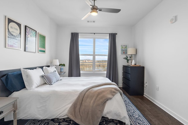 bedroom featuring ceiling fan and dark wood-type flooring