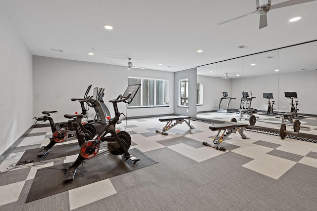 exercise room with ceiling fan and light carpet