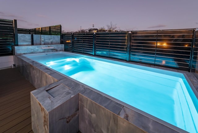 view of swimming pool with a jacuzzi