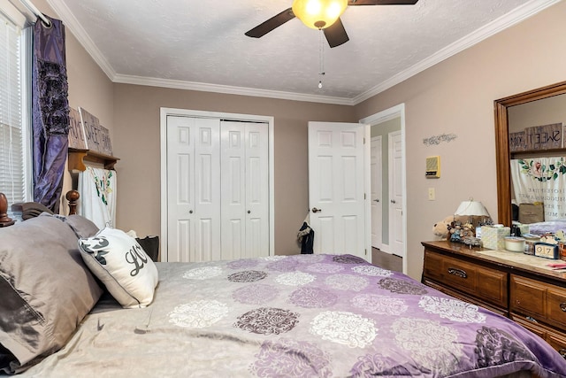 bedroom featuring ceiling fan, a closet, crown molding, and a textured ceiling