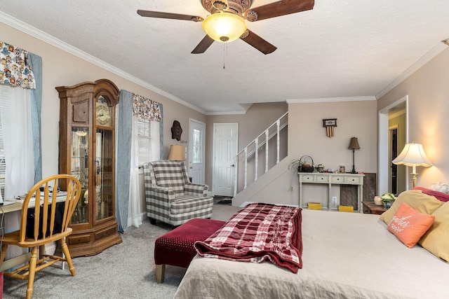 bedroom with carpet, crown molding, ceiling fan, multiple windows, and a textured ceiling