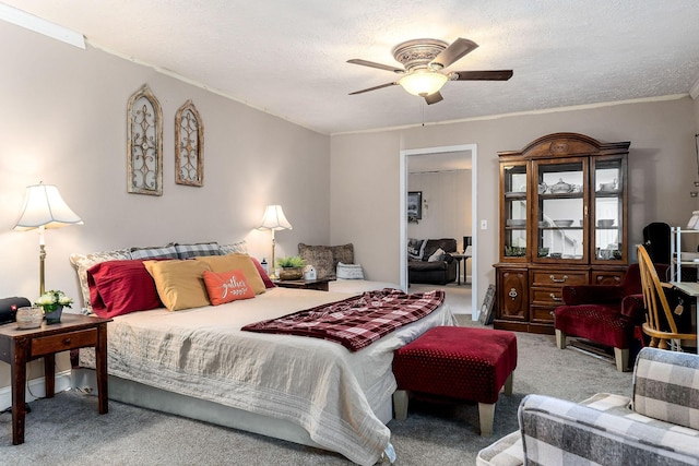 carpeted bedroom featuring ceiling fan, ornamental molding, and a textured ceiling