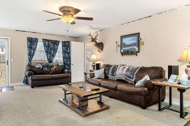 carpeted living room with ceiling fan