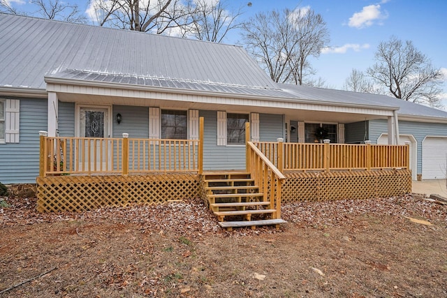 back of property featuring a garage and covered porch