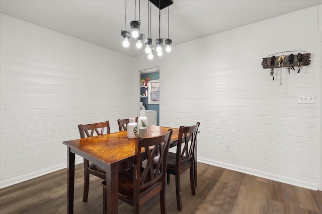 dining space with washer / clothes dryer and dark wood-type flooring