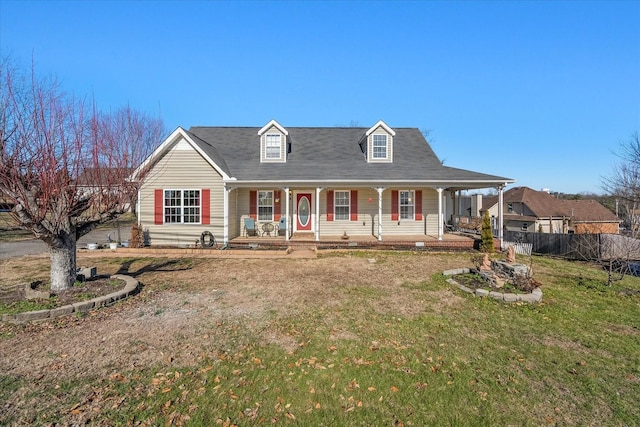 cape cod home with a front lawn and a porch