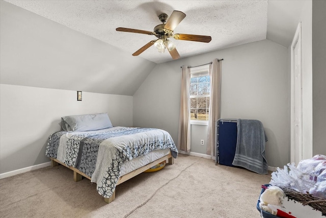 carpeted bedroom featuring ceiling fan, a textured ceiling, and lofted ceiling