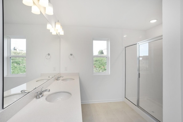 bathroom with a shower with door, vanity, and a notable chandelier