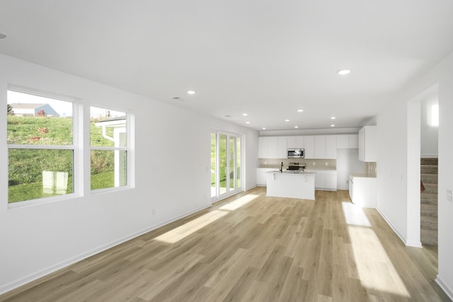 unfurnished living room featuring light hardwood / wood-style floors