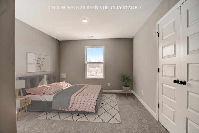 bedroom featuring a closet and light carpet