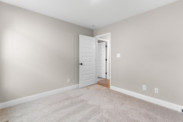 empty room featuring light colored carpet