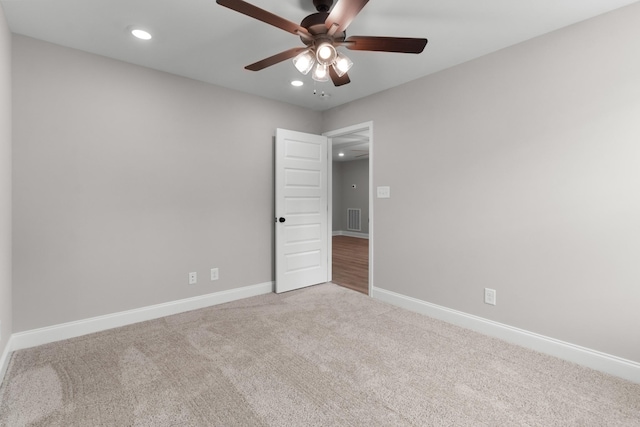 spare room featuring ceiling fan and carpet