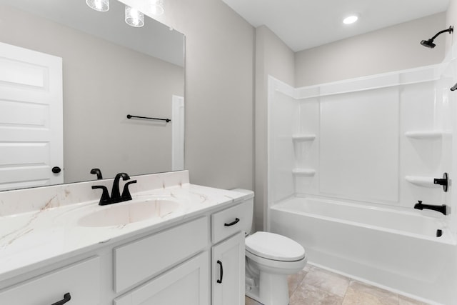 full bathroom featuring washtub / shower combination, vanity, and toilet