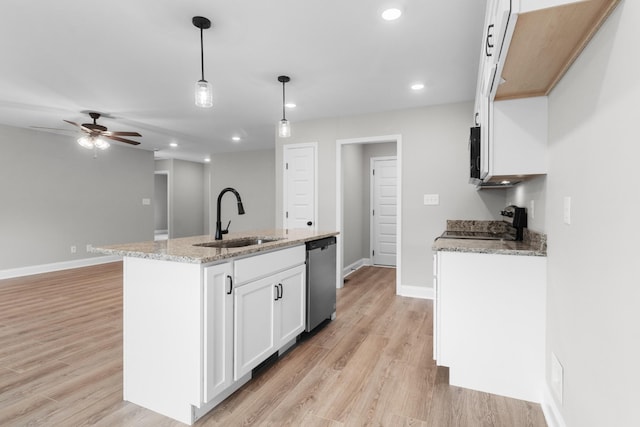 kitchen with a kitchen island with sink, hanging light fixtures, white cabinets, stainless steel dishwasher, and sink