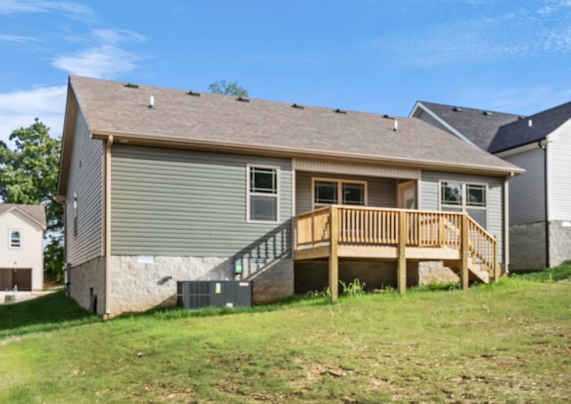 rear view of property featuring a yard, central AC, and a wooden deck