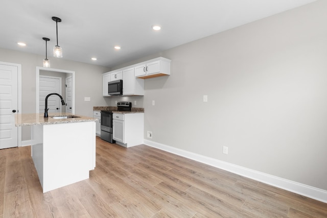 kitchen with sink, decorative light fixtures, white cabinetry, electric stove, and a kitchen island with sink