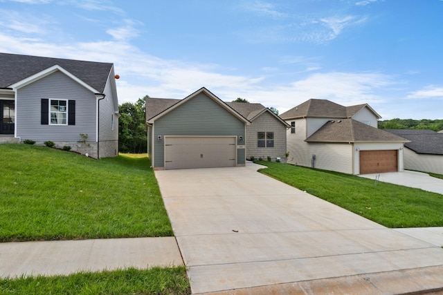 view of front of property with a front yard and a garage