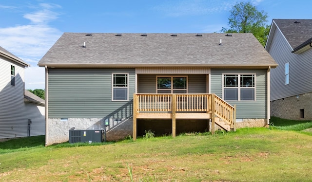 back of house with central AC, a wooden deck, and a lawn