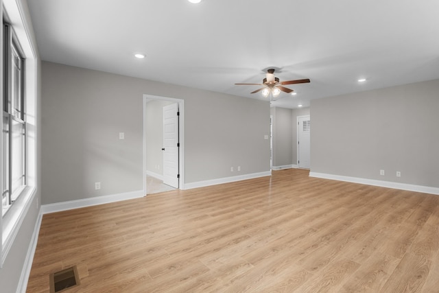 empty room featuring ceiling fan and light hardwood / wood-style flooring