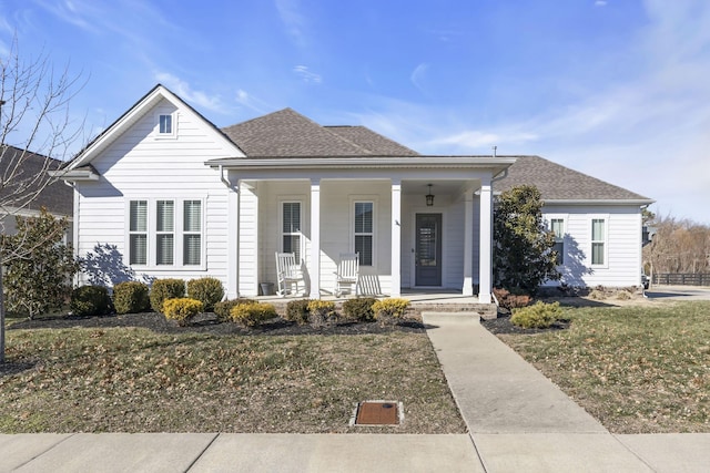 view of front of house featuring covered porch and a front yard