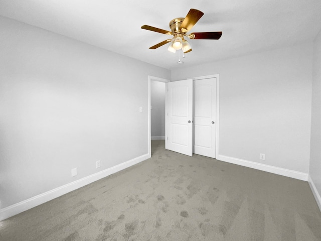 unfurnished bedroom with ceiling fan, a closet, and carpet flooring