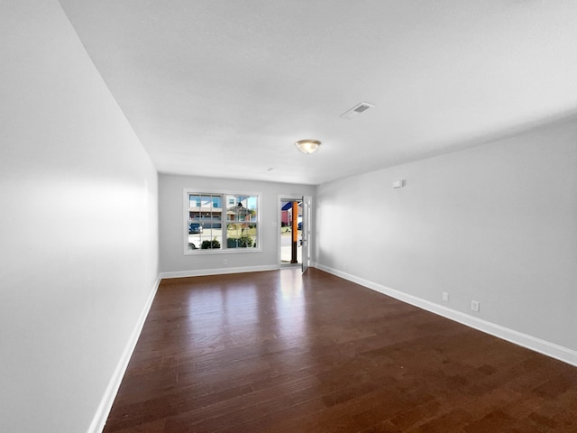 spare room featuring dark hardwood / wood-style flooring