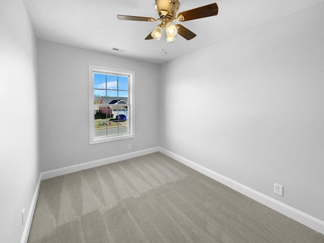 unfurnished room featuring ceiling fan and carpet