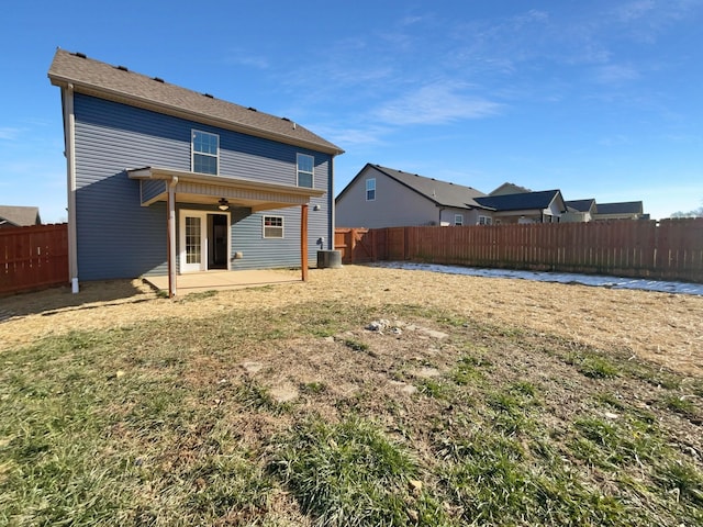 rear view of property with central AC unit, ceiling fan, a patio area, and a lawn