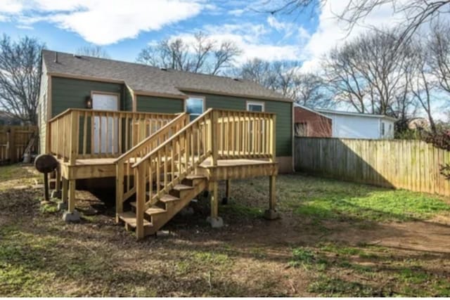 rear view of property featuring a deck