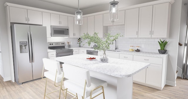 kitchen with decorative light fixtures, backsplash, white cabinetry, and stainless steel appliances