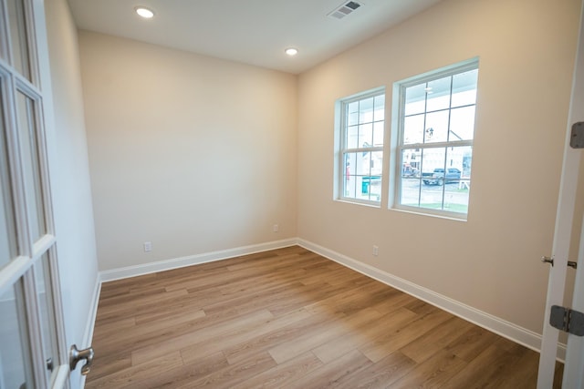 unfurnished room with light wood-type flooring