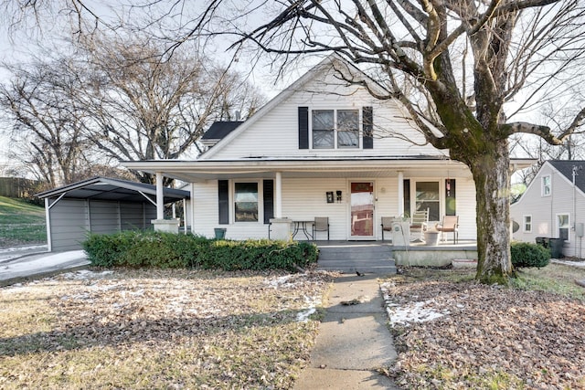 bungalow-style house featuring covered porch and a carport