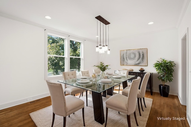 dining area featuring crown molding and dark wood-type flooring