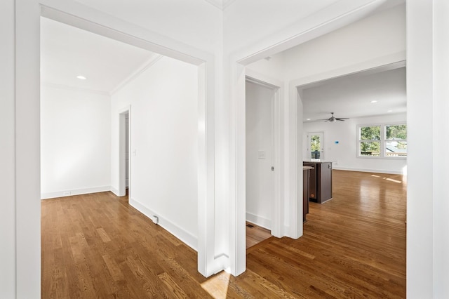 hall featuring hardwood / wood-style flooring and crown molding